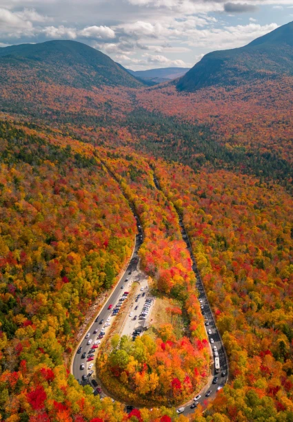 Aerial view of a mountain road through fall foliage