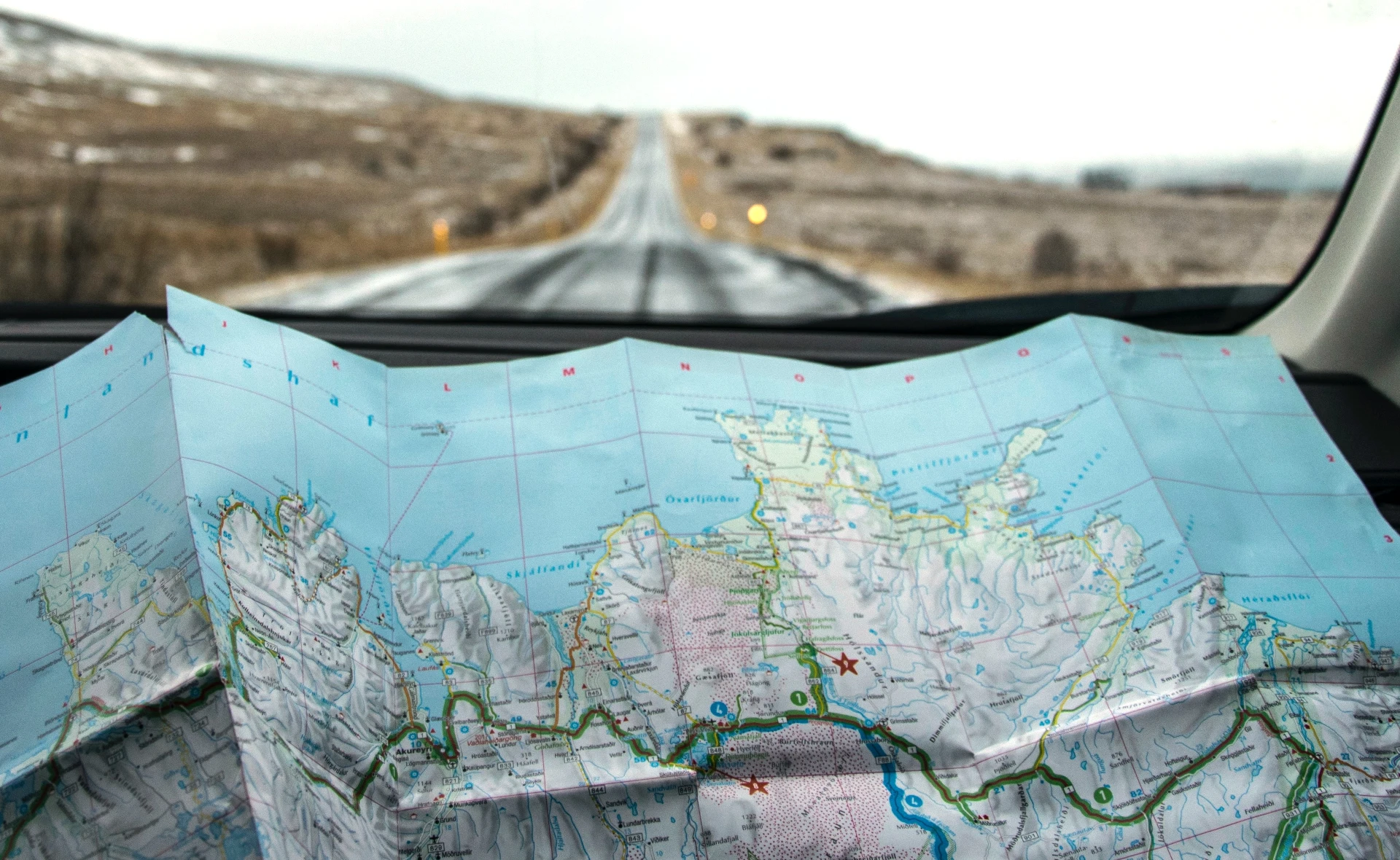 Road map spread across a car dashboard
